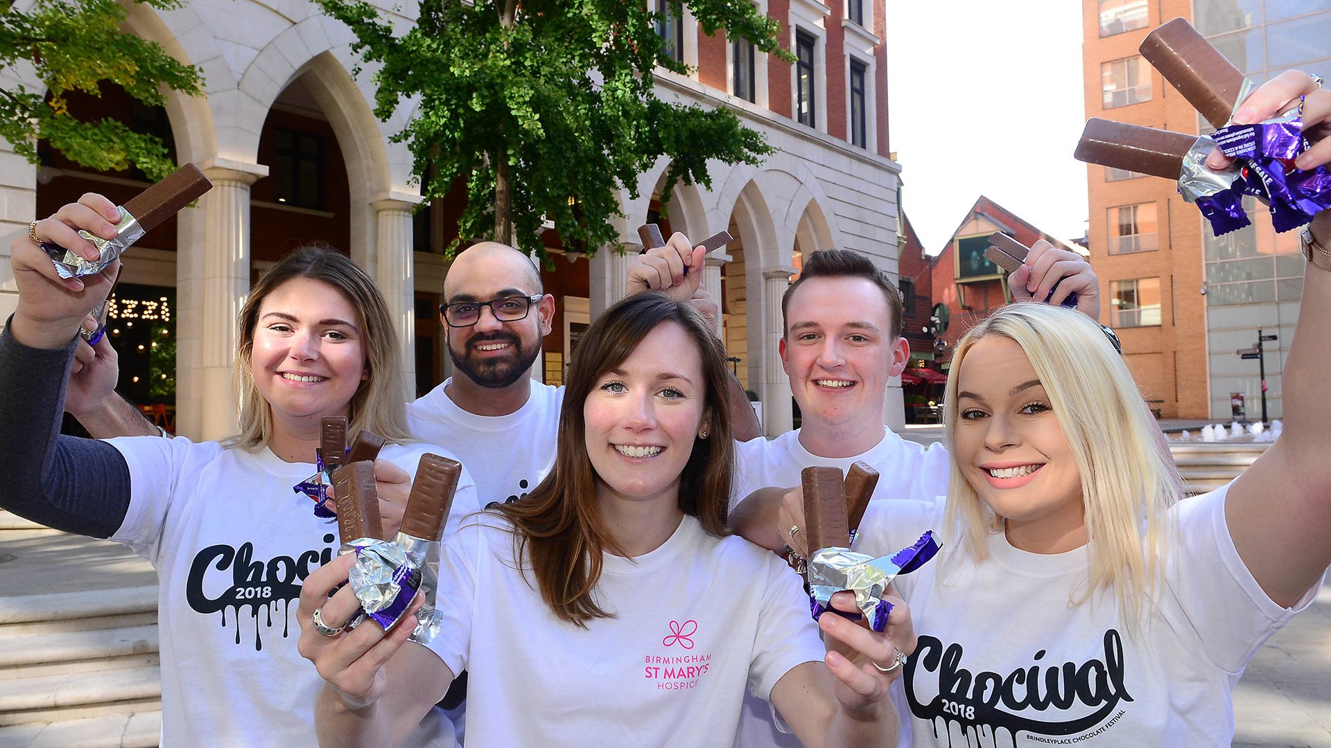 Group of people holding chocolate bars at Brindleyplace in Birmingham.