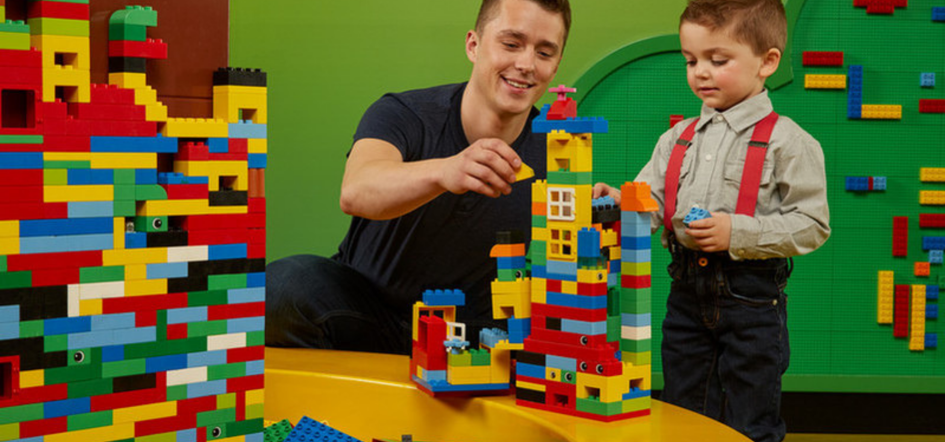 Father and child playing with lego at LEGO LAND discovery centre in Birmingham.