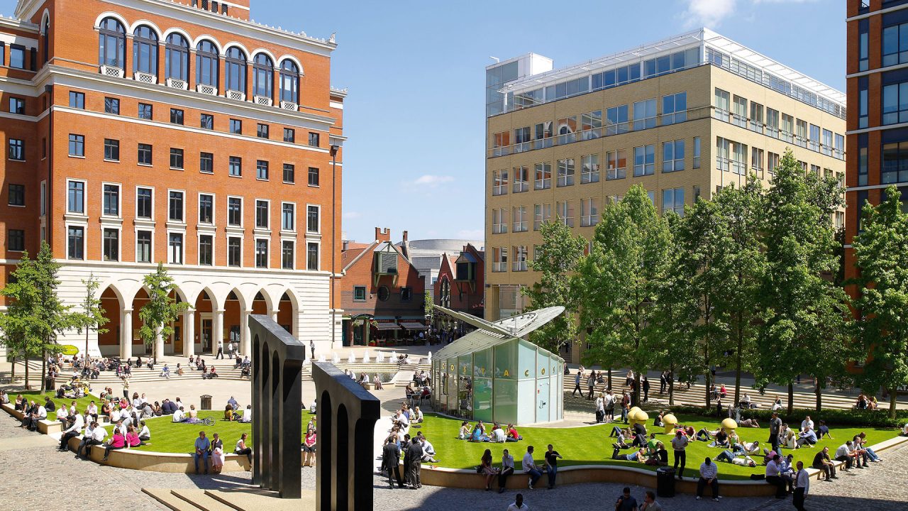 Crowd of people relaxing at Central Square in Brindleyplace, Birmingham.