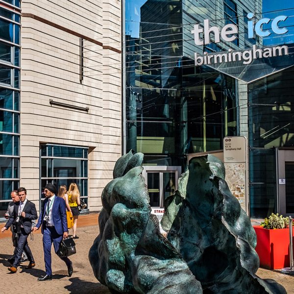 People walking through the ICC in Birmingham on a sunny day.