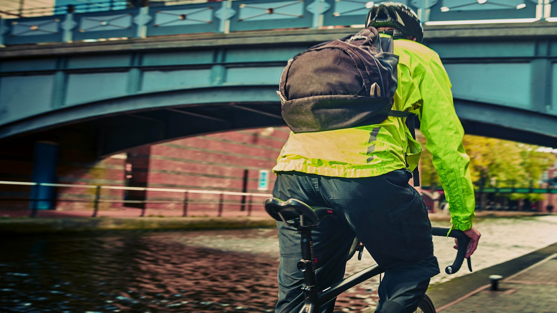 Man riding a bike on the canal paths at Brindleyplace.