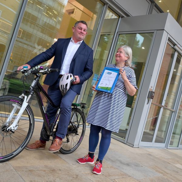 Matt Long, senior asset manager for Praxis at Brindleyplace stands with a bike while Councillor Liz Clements, cabinet member for Transport at Birmingham City Council holds the Green/Approved Modeshift STARS Travel Plan accreditation while in front of Foundry 6 Brindleyplace.